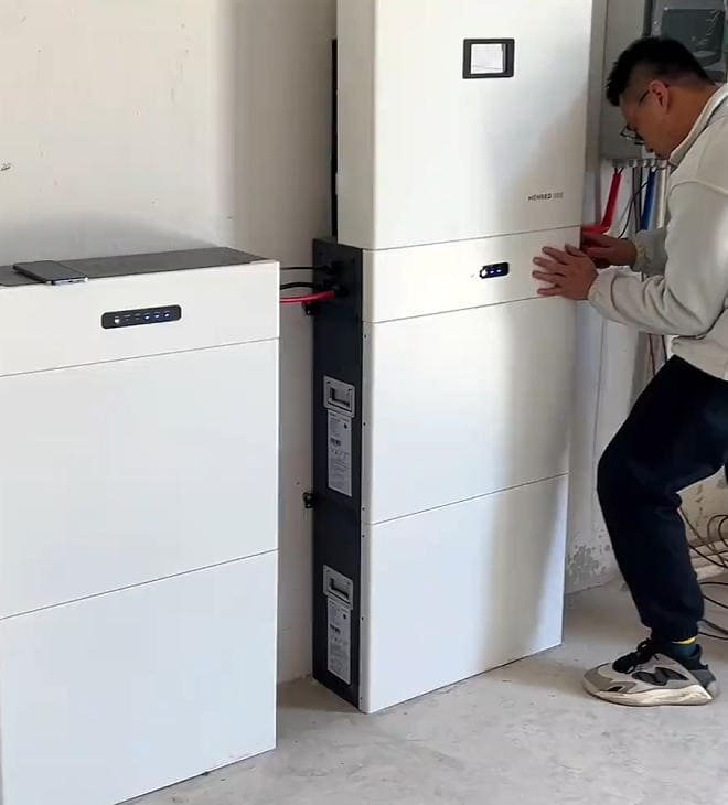 Saftec technician checking connections of residential battery system