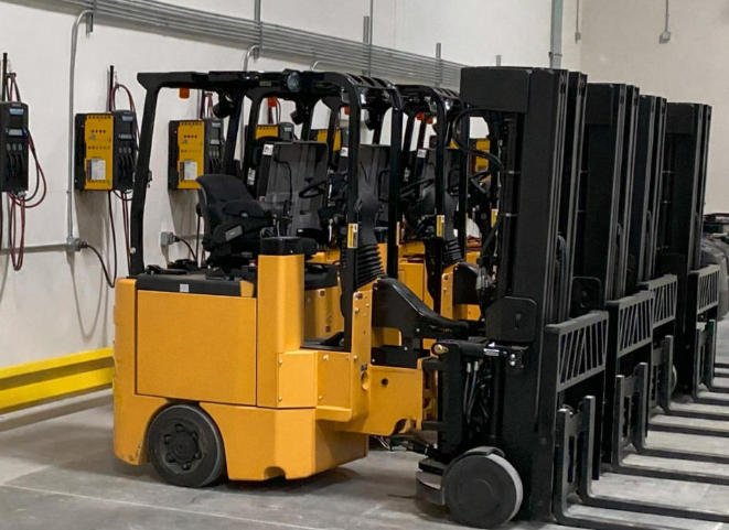 Lithium Forklift Battery charging area with multiple forklifts parked nearby
