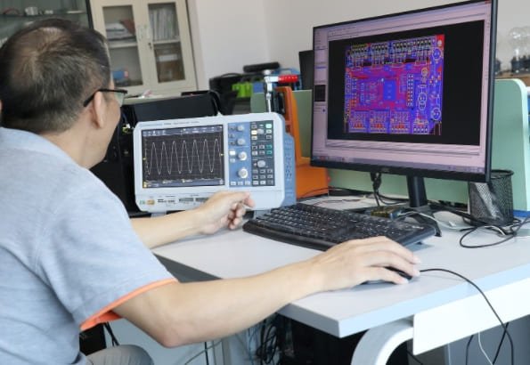 Production team assembling lithium golf cart and motive power packs with LiFePO4 cells - saftecenergy